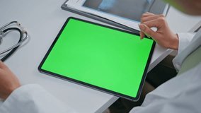 Medic hand pointing chroma key tablet in polyclinic closeup. Unknown woman doctor touching green screen gadget at medicare work. Physician using mockup computer at healthcare medical consultation. - Powered by Shutterstock - Get 15% off with code: PIKWIZARD15
