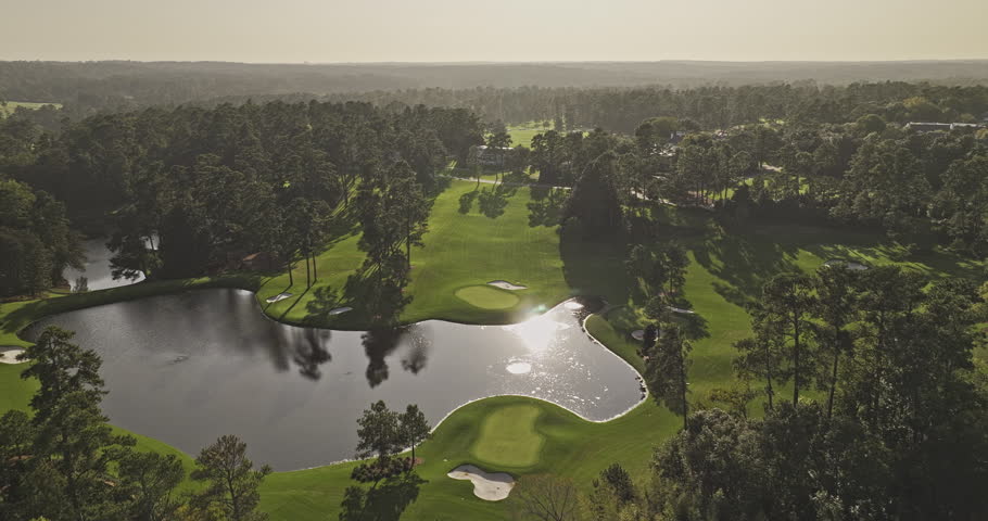 Augusta Georgia Aerial v59 cinematic drone flyover around the National Golf Course, capturing sunset views of the lush fairways, lake, and cityscape - Shot with Mavic 3 Pro Cine - October 2023