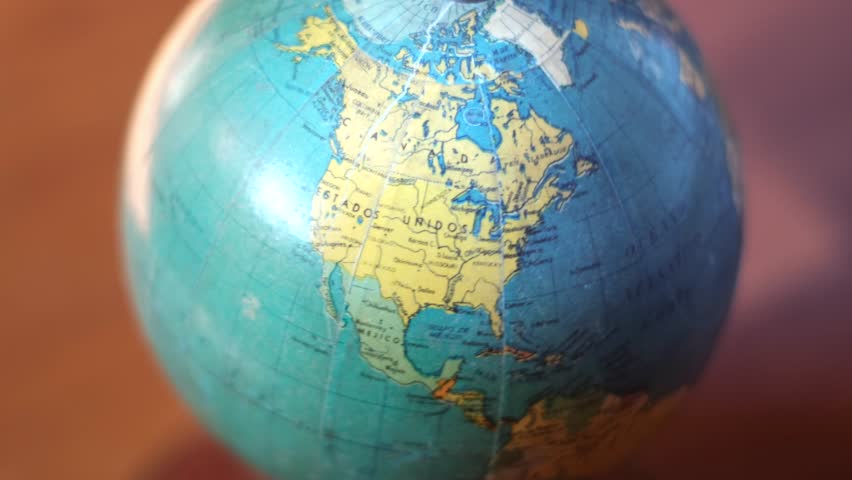 Close-up of spinning globe showing Atlantic Ocean and surrounding continents