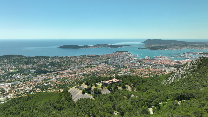 Toulon city and Mediterranean sea. Fort Faron in foreground, France. Aerial backwards