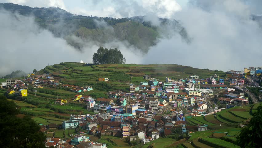 Aerial of Poombarai village covered in clouds in Kodai hills