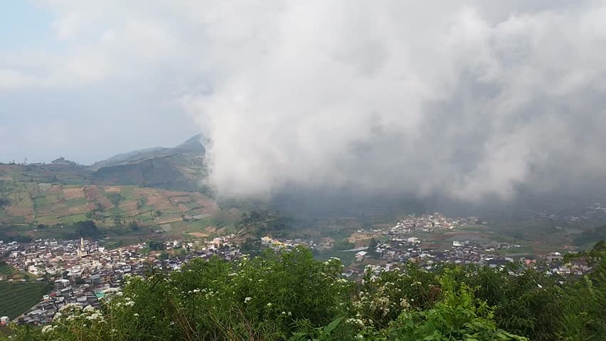 A time lapse of fog moving over people