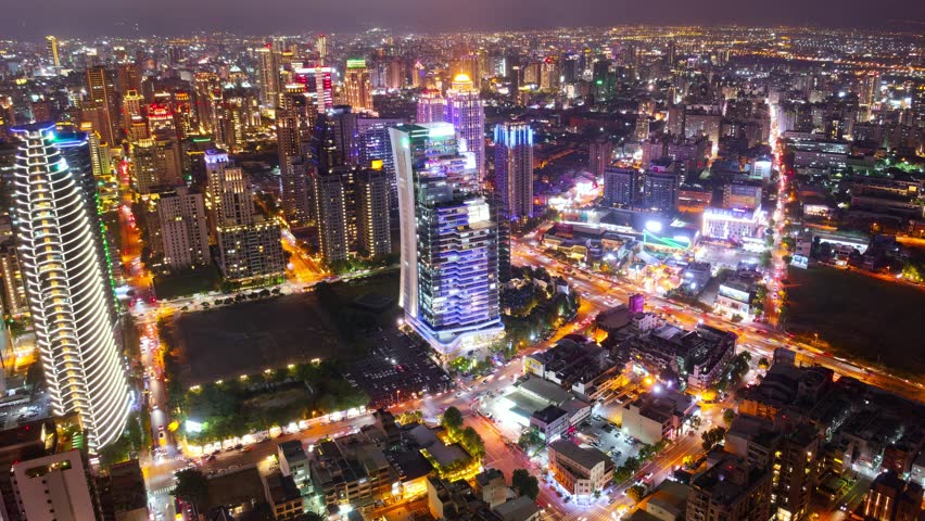 Aerial skyline of Downtown Taichung, a vibrant metropolis in central Taiwan, with modern high-rise office towers booming in the 7th Redevelopment Zone and city lights dazzling at night (in hyperlapse)