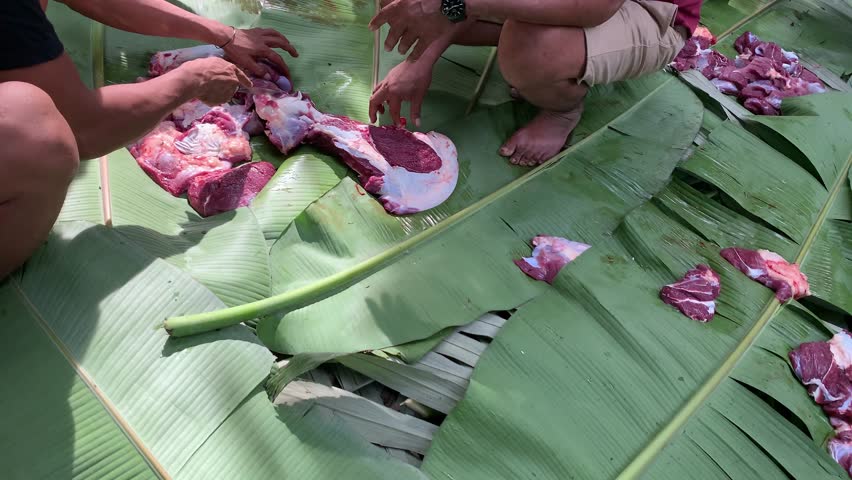 butcher cut the beef meat on sacrifice day eid-al-adha