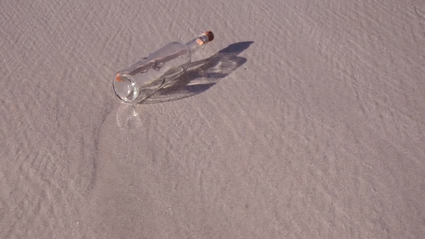Bottle Message with waves on the beach