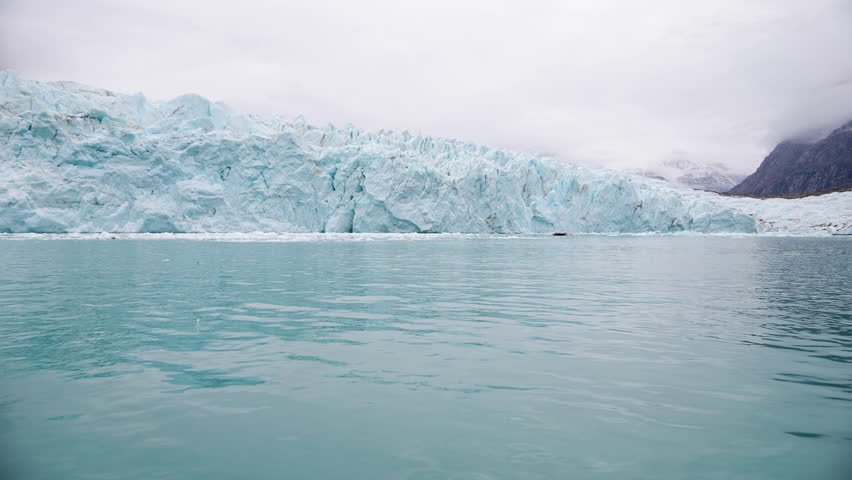Glacier and Cold Arctic Sea, Coast of Greenland on Misty Day