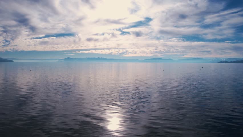 Aerial View of Sky and Clouds Mirror Reflection on Calm Water of Lake Tahoe USA on Sunny Winter Day