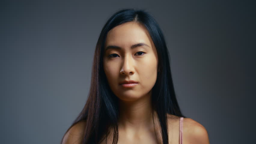 Young woman unhappy with dull face skin, dehydrated skin, lack of moisturizer