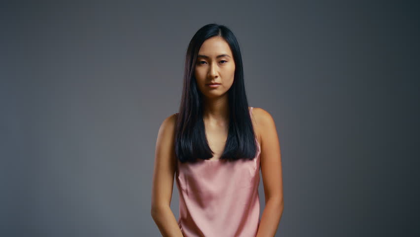 Asian woman unhappy with her hair, dandruff, lack of vitamins, split ends