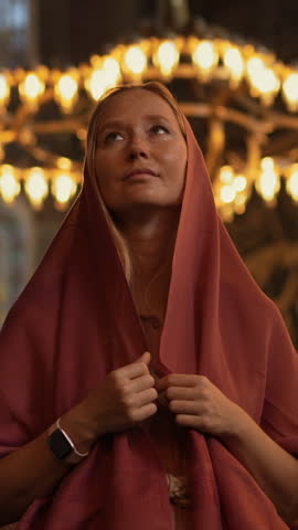 In the heart of Istanbul, a scarf-clad woman tourist stands before Ayasofya