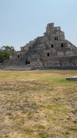 Tourist woman walking in the Mayan ruins of the Edzná Pyramid, Campeche, Mexico. Temple located in the jungle of the Yucatan peninsula. Turistic destination in Riviera Maya, Valladolid and Merida