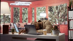 Entrepreneur sleeping on his home office desk after stressful analysis for the online business he is running. Tired fatigued businessman getting some rest with a nap, burnout. Camera B. - Powered by Shutterstock - Get 15% off with code: PIKWIZARD15