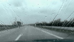 Driving a car on wet slippery road at rain with window covered in raindrops - Powered by Shutterstock - Get 15% off with code: PIKWIZARD15