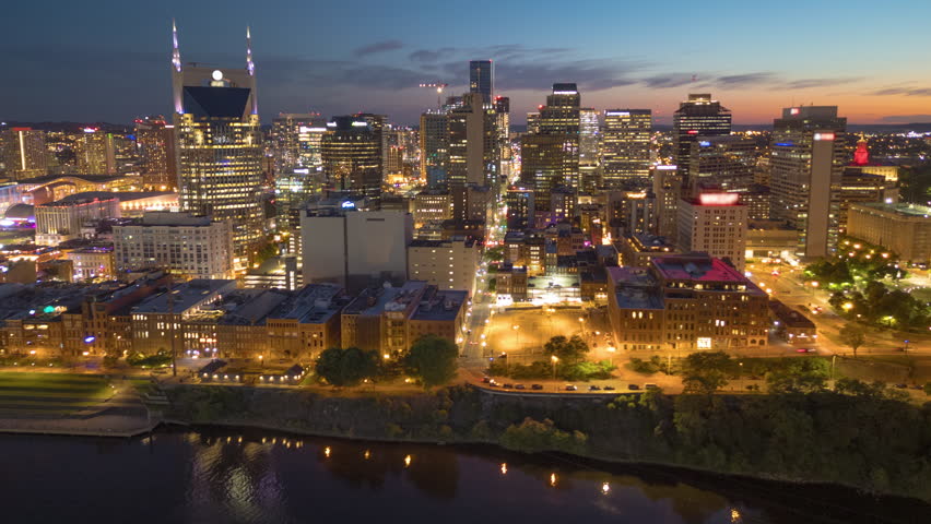 Nashville, Tennessee, USA skyline over the Cumberland River at golden hour.