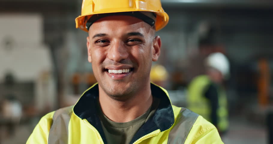 Helmet, worker and portrait of man in construction, safety and industry of engineering, warehouse and building. Industrial, happy and face of person, smile and joy of employee in factory for storage
