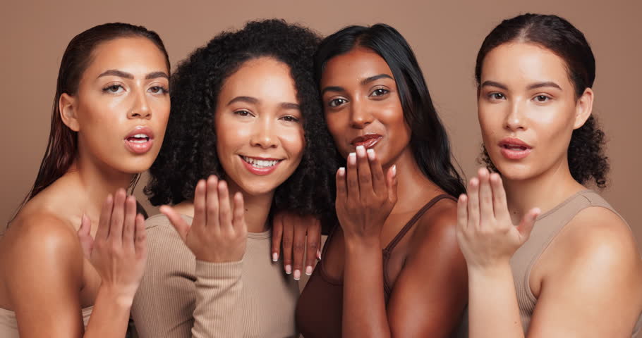 Women, face and blow kiss in studio for skincare with diversity, natural makeup and beauty with wellness of routine. Female people, background and happy with pride for equality, dermatology and shine
