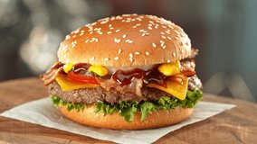 Delicious Hamburger with Cheese, Camera Moving Around. Fresh Junk Food with Beautiful Bokeh Kitchen Background. Cheeseburger Ready to Eat. Speed Ramp Effect. - Powered by Shutterstock - Get 15% off with code: PIKWIZARD15