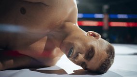 Portrait of a Knocked Out Boxer Falling on the Ground. Close Up of the Head Hitting the Floor, Fighter is Almost Unconscious and Seriously Disorientated. Hurt Mixed Martial Artist Losing a Match - Powered by Shutterstock - Get 15% off with code: PIKWIZARD15