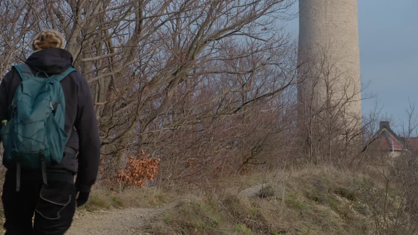 A footage of Caucasian young men walking through forest towards the Fuchsturm, near Jena in Thuringia, Germany