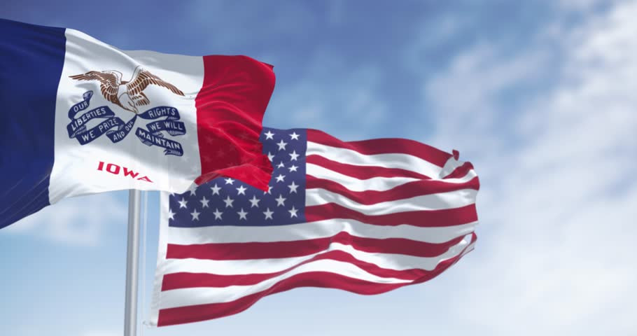 Iowa state flag waving in the wind with the American national flag on a clear day. Seamless 3d render animation. Slow motion loop. Selective focus