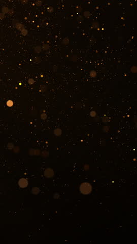 Golden glitter floating in the air. Concept of Merry Christmas and Happy New Year.