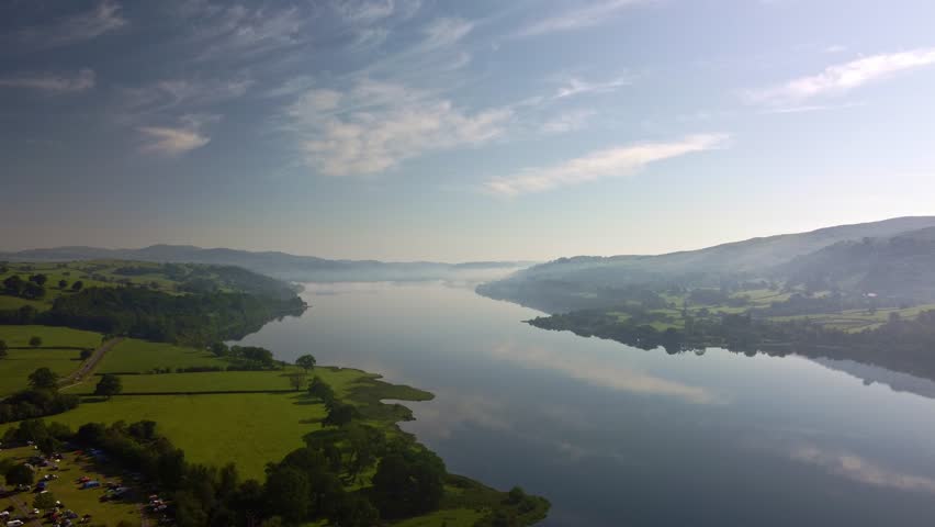 Aerial 4K Drone footage of Lake Bala, North Wales. Video moves across the wight of the lake showing the beautiful surroundings on a bright, sunny, summers day.