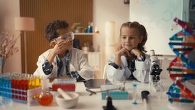 Schoolchildren in lab coats think about school project, get an idea, creativity - Powered by Shutterstock - Get 15% off with code: PIKWIZARD15