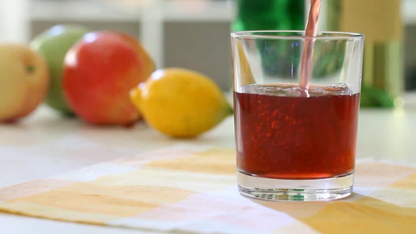 Fruit juice is poured In the glass