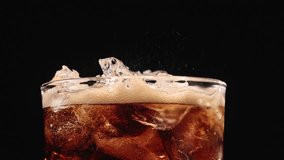 Closeup of pouring cola drink with ice cubes. Fizzing cola with ice in glass. Refreshing tasty cola drink. - Powered by Shutterstock - Get 15% off with code: PIKWIZARD15