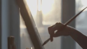 In the soft morning light, the artist demonstrates dedication and talent by skillfully creating a beautiful painting on canvas with meticulous attention to detail, creativity, and craftsmanship - Powered by Shutterstock - Get 15% off with code: PIKWIZARD15