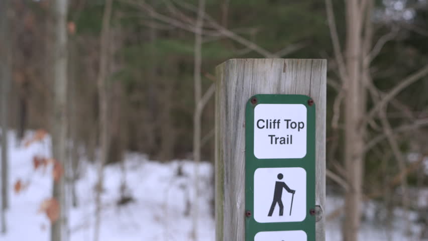 A close-up shot of trail indicator sign named "Cliff Top Trail".