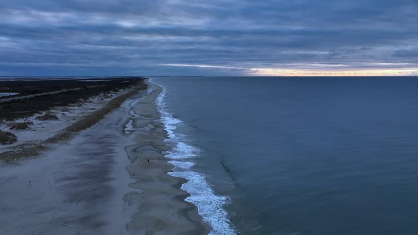 A time-lapse drone shot of Jones beach with a seascape view  on a gloomy day
