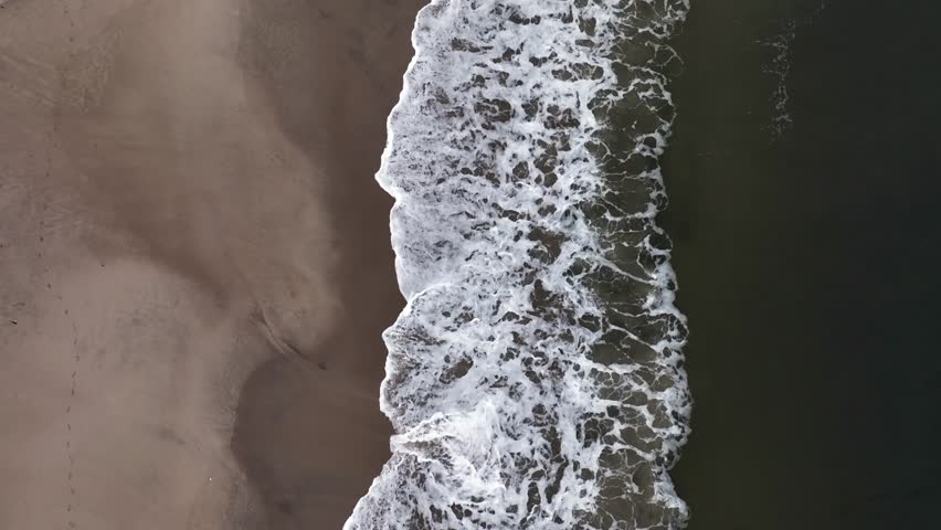 A time-lapse drone shot of Jones beach with a seascape view  on a gloomy day