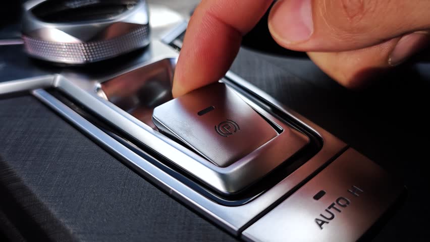 Electronic parking brake with Auto-hold. Modern car. Pressing the handbrake button in a car.