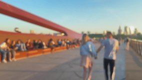 Bicycle and pedestrian bridge over the Vistula. Warsaw, Poland. Many people walk along the bridge. Out of focus. - Powered by Shutterstock - Get 15% off with code: PIKWIZARD15