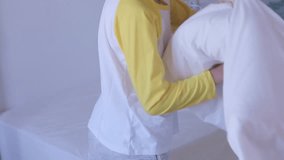 funny pillow fight in in bedroom, happy children, two healthy boys 9-10 years old playfully beat each other with pillows, play together on bed, happy childhood, active games funky siblings at home - Powered by Shutterstock - Get 15% off with code: PIKWIZARD15