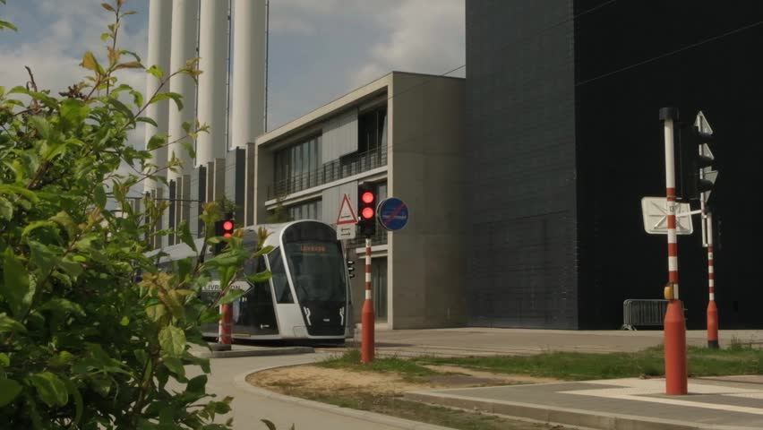 Modern tram arrives at the station in a beautiful city Luxembourg. Free public transportation in Luxembourg