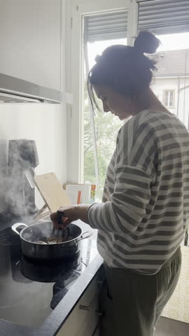 Join a woman as she prepares her everyday meal on an induction stove in the comfort of her home during the day