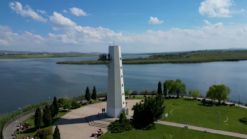 GROUP OF PEOPLE ON THE OBSERVATION TOWER WITH LAKE VIEW DRONE SHOOTING 4K 60FPS