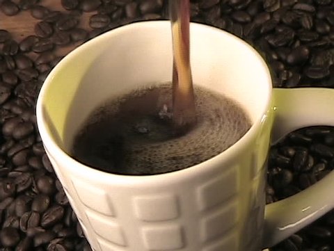 Pouring coffee into a mug.