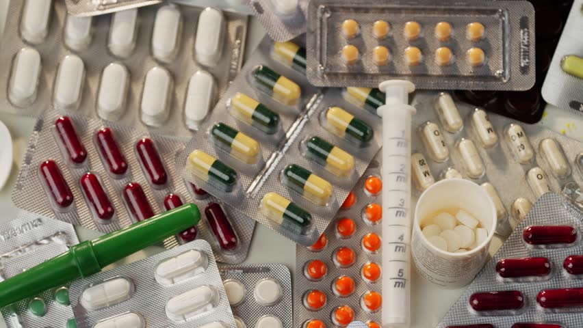 Detailed View of Prescription Pills Cascading onto Medicine Boxes. High quality 4k footage