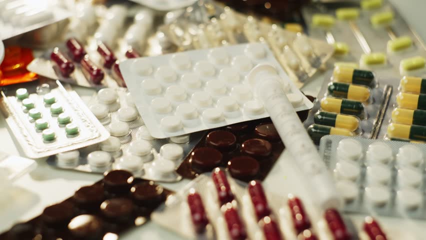 Background video close-up of various pills in bundles. Medicine and drug treatment at home. High quality 4k footage