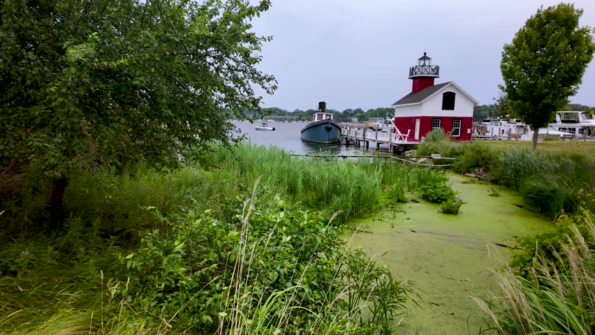Scenic landscape of Saugatuck Douglas lighthouse at Lake Michigan shore line.