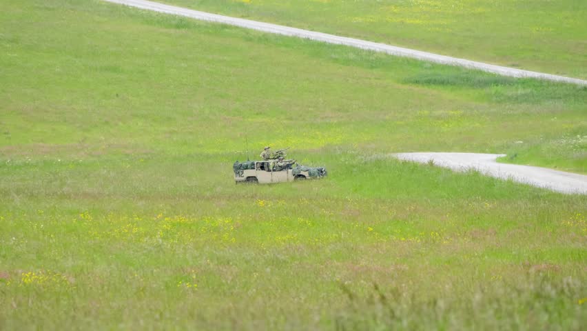 British army RWMIK (Revised Weapons Mounted Installation Kit) vehicle in action on a military exercise, UK