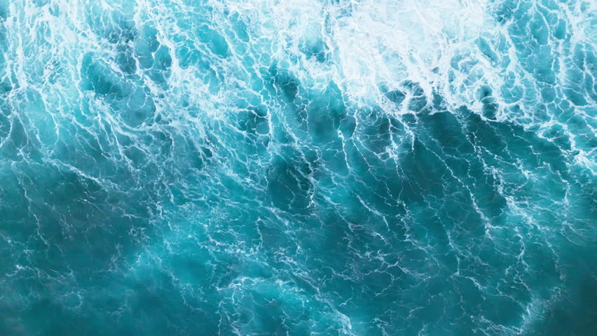 Top-down aerial view of the powerful deep blue ocean waves during the monsoon season