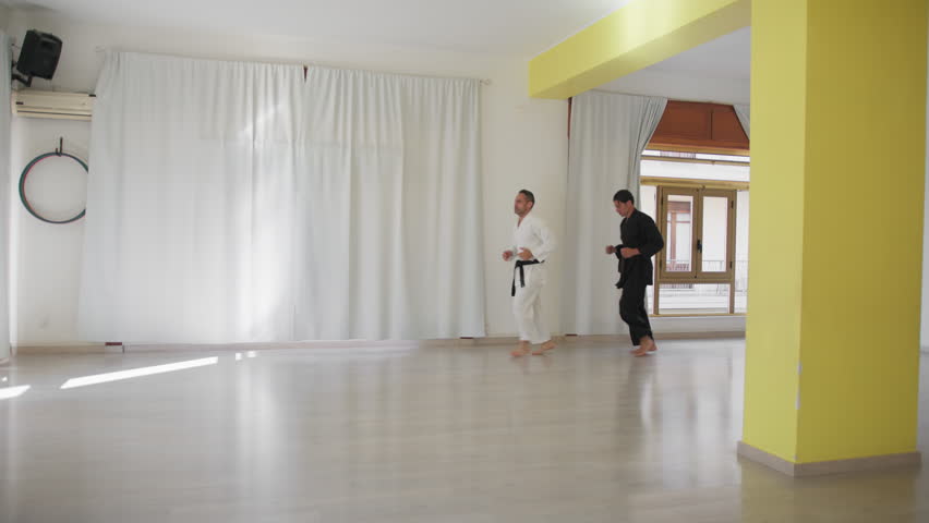 Two Men Are Walking Into The Hall For A Karate Lesson
