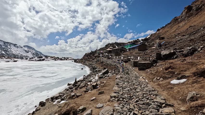 View over the pristine frozen mountain lake in early morning sunlight. Gosaikunda holy lake of Buddhist and Hindu. Nepal, Lantang National Park Himalayas