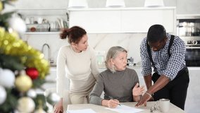 Elderly woman relatives tell her who to include in her will during Christmas celebrations. High quality 4k footage - Powered by Shutterstock - Get 15% off with code: PIKWIZARD15