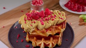 Belgian waffle decorated with raspberries and glazed. Concept of exquisite dessert. - Powered by Shutterstock - Get 15% off with code: PIKWIZARD15