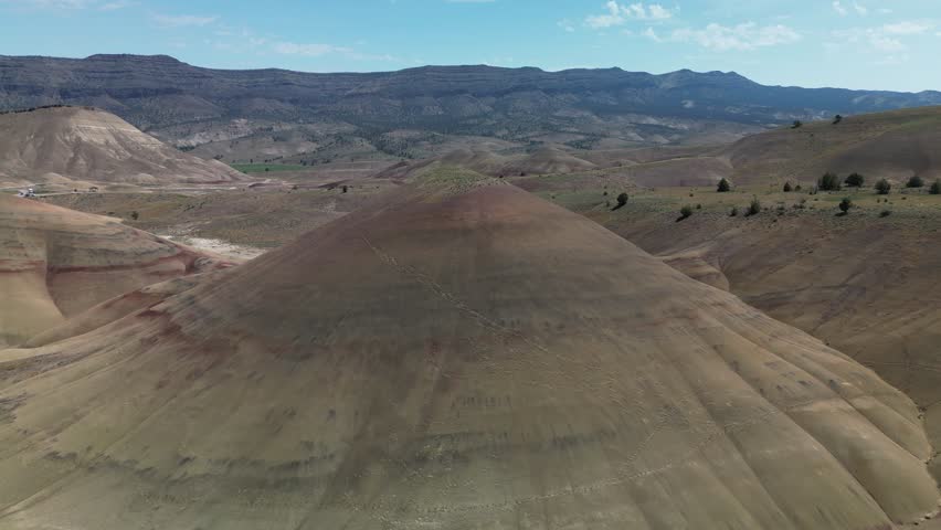 A drone footage of the scenic Painted Hills and John Day Fossil Beds Park on a sunny day in east-central Oregon, United States